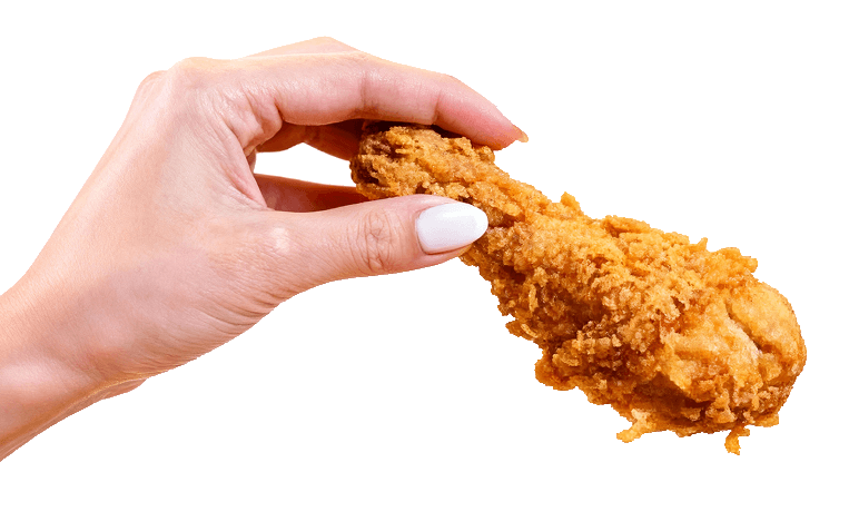 Hand holding a piece of fried chicken